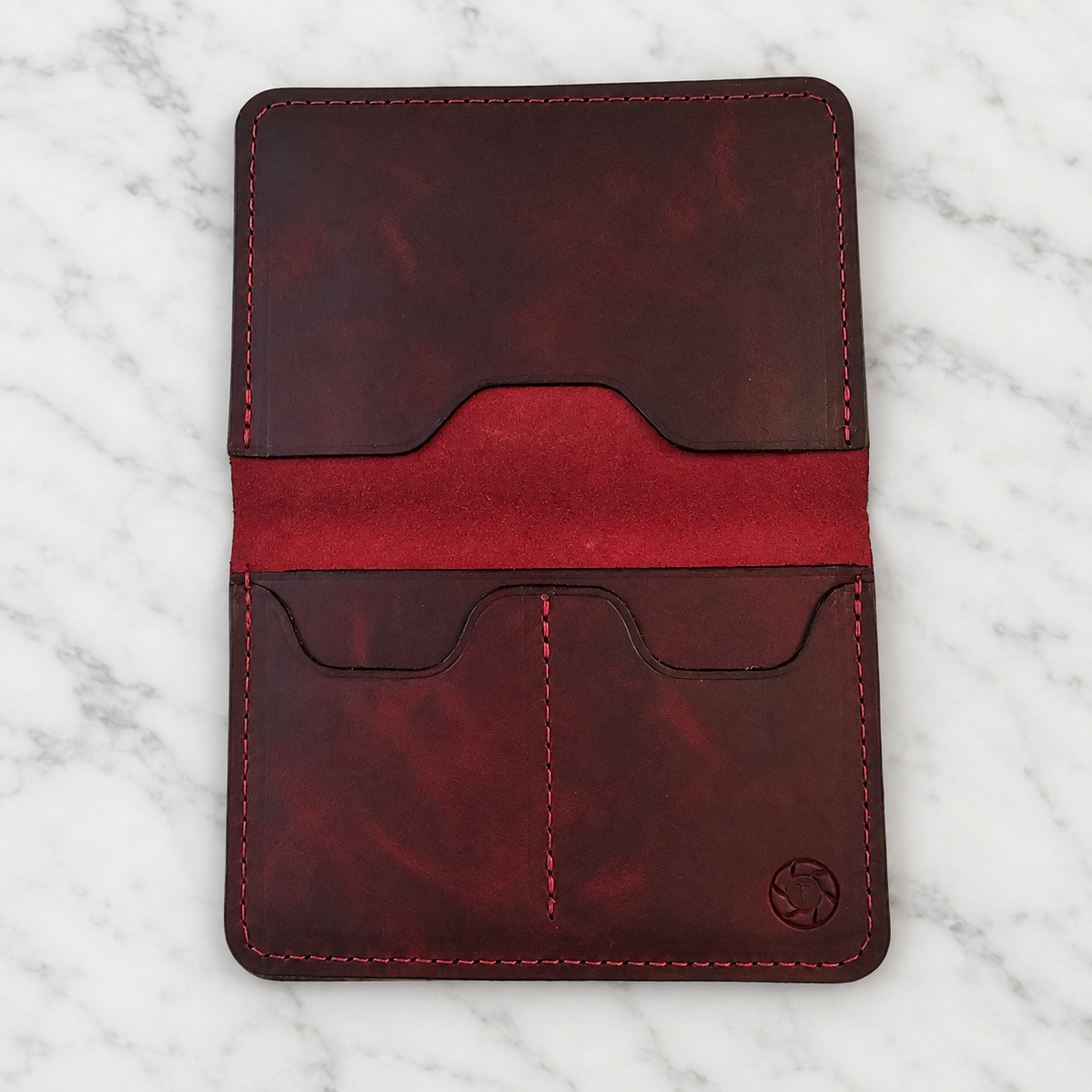 Volcano Burgundy Leather Passport Holder on light marble background