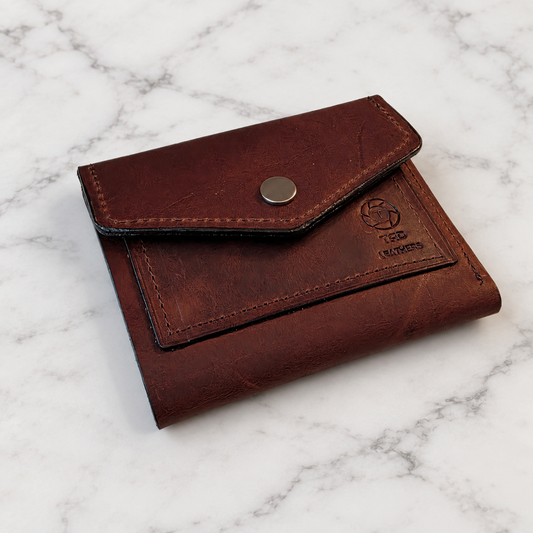 Volcano Brown Full-Grain Leather Snap Wallet on light marble background
