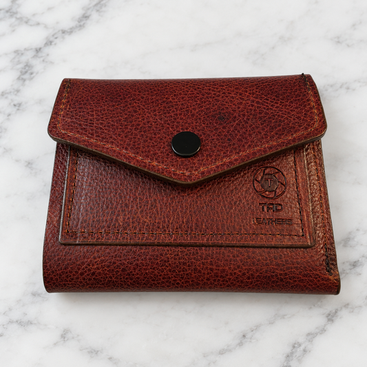 Multi-Brown Leather Snap Wallet with ID Window on light marble background