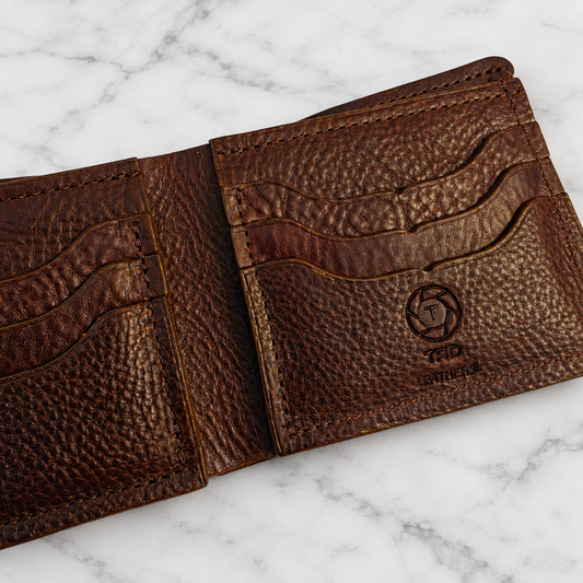Dark Brown Full-Grain Leather Bifold Wallet on light marble background