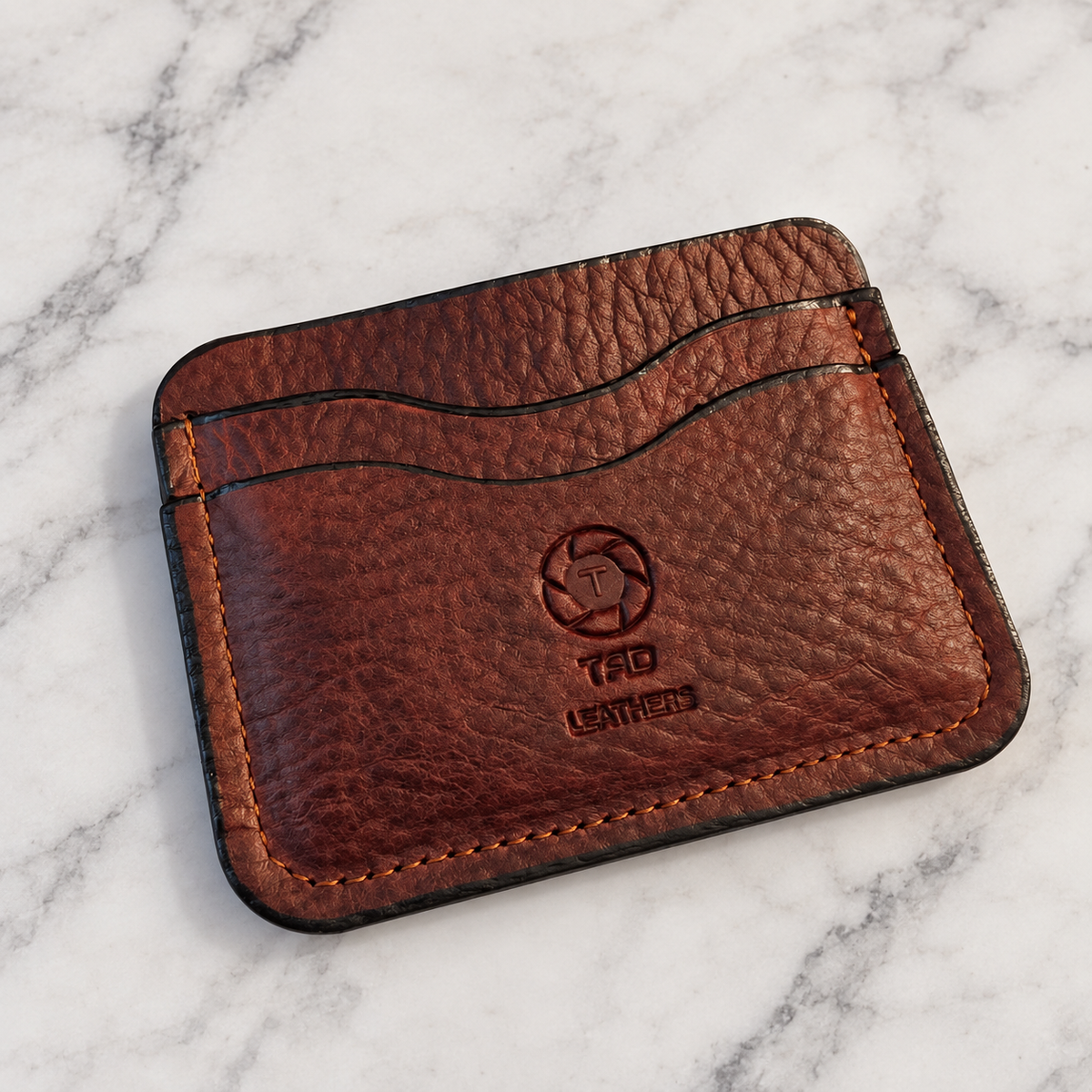Pebbled Brown Leather Cardholder on light white and gray marble background