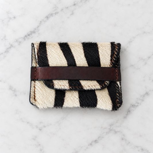 Savanna Stripe Zebra-Pattern Hair-on-Hide Leather Pouch on light marble background