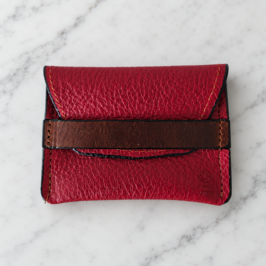 Crimson Ridge Pebbled Leather Keeper Pouch on light marble background