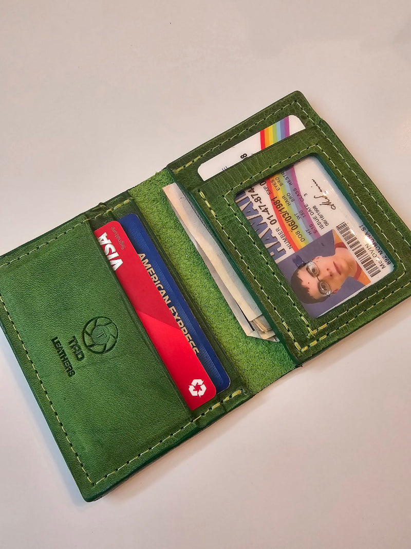 Green wallet with cards and a photo card on a light gray background