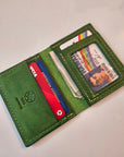 Green wallet with cards and a photo card on a light gray background