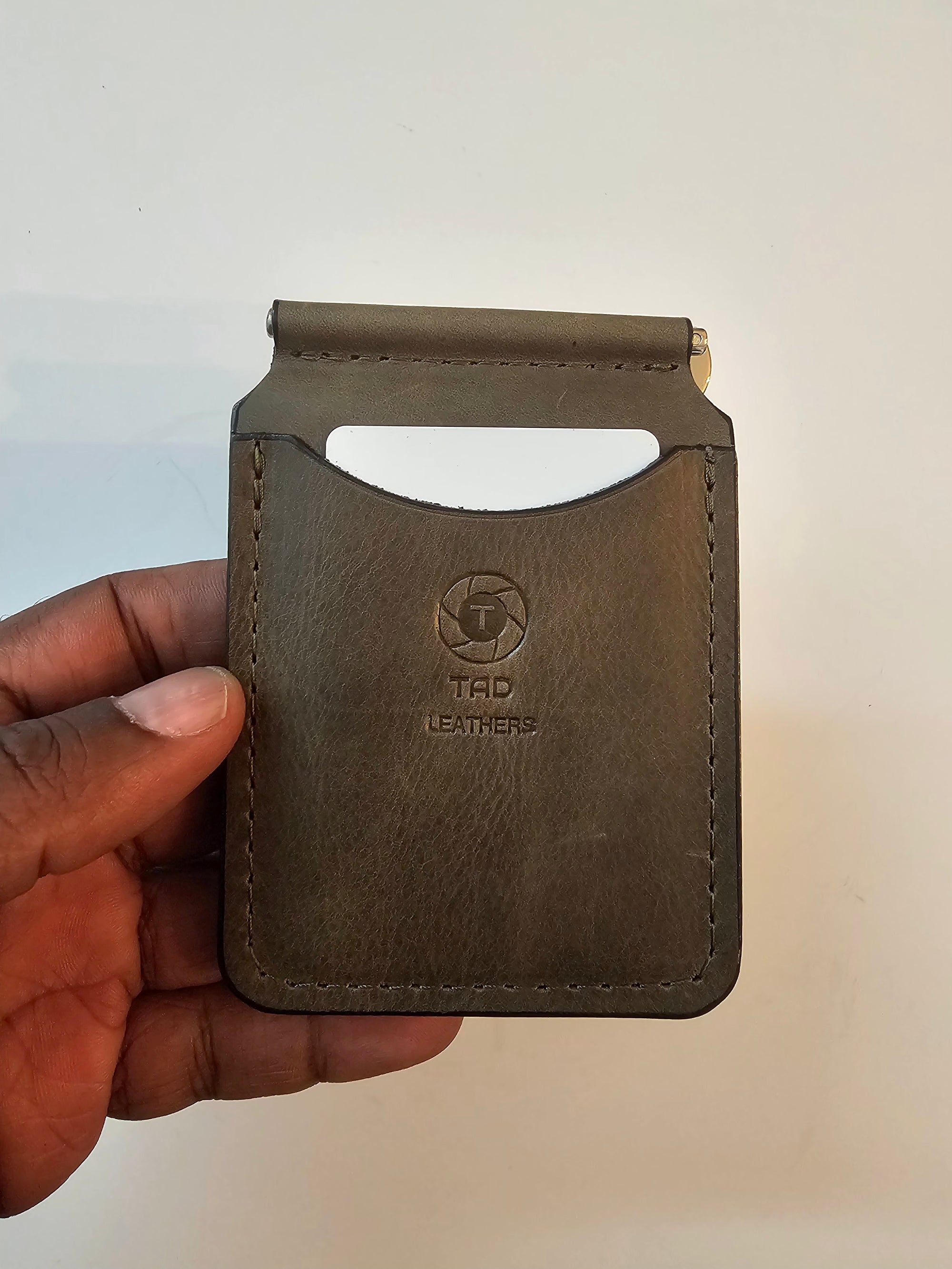Handcrafted olive green leather money clip with natural finish by Tad Leathers