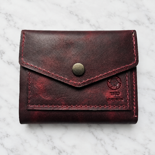 Handmade Red Leather Snap Wallet on light white and gray marble background