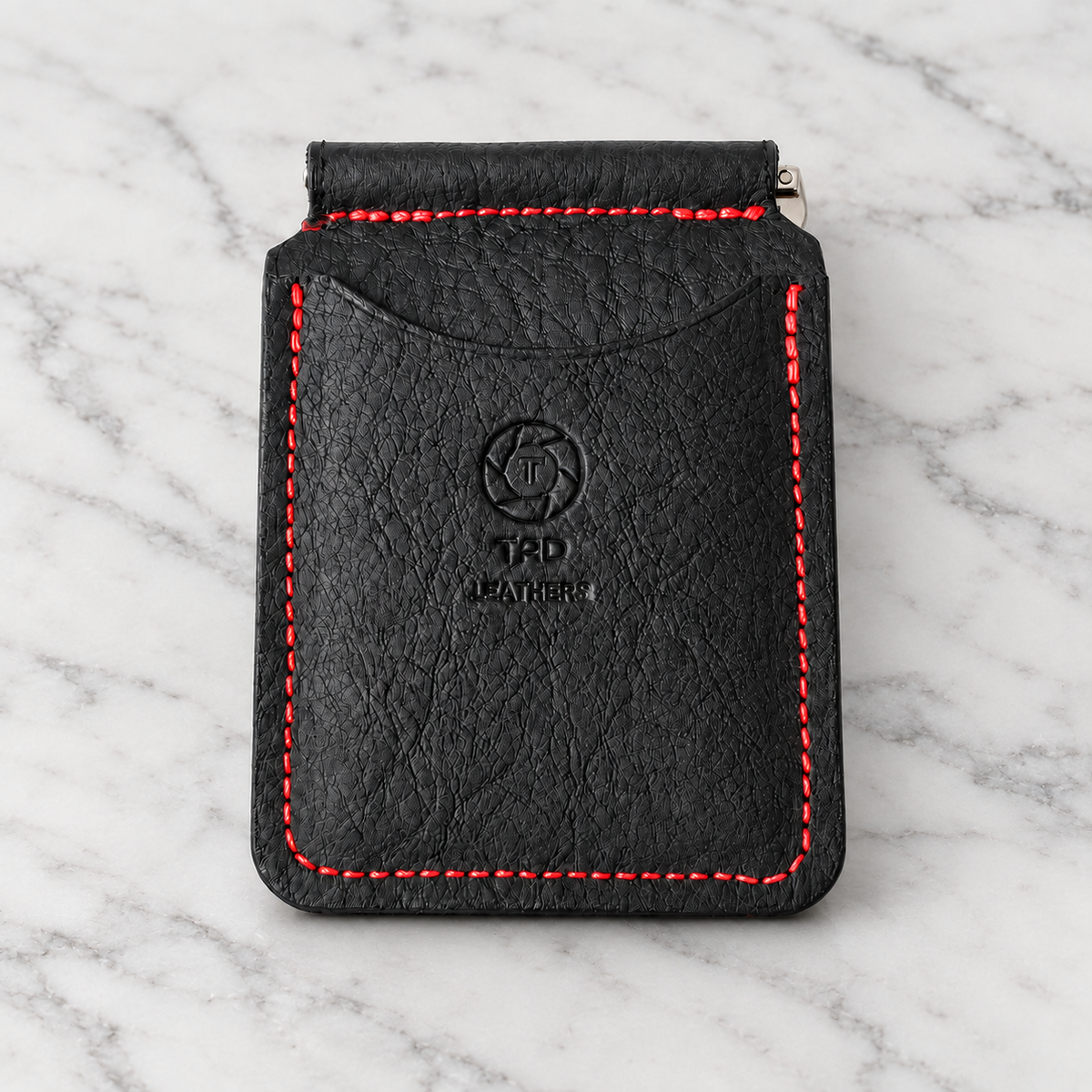 Black & Red Leather Money Clip Wallet on light marble background