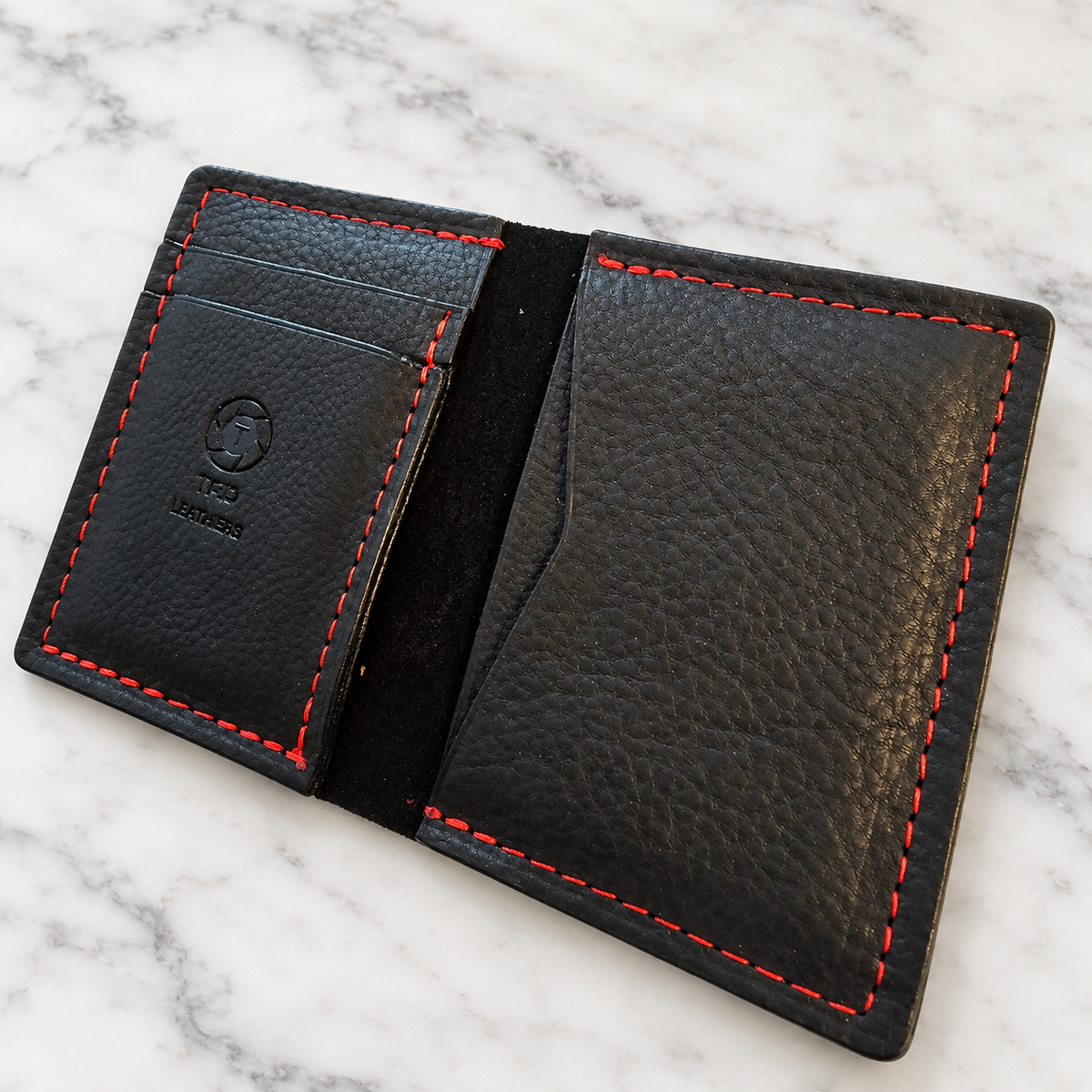 Midnight Ember Full-Grain Leather Minimalist Wallet on light marble background