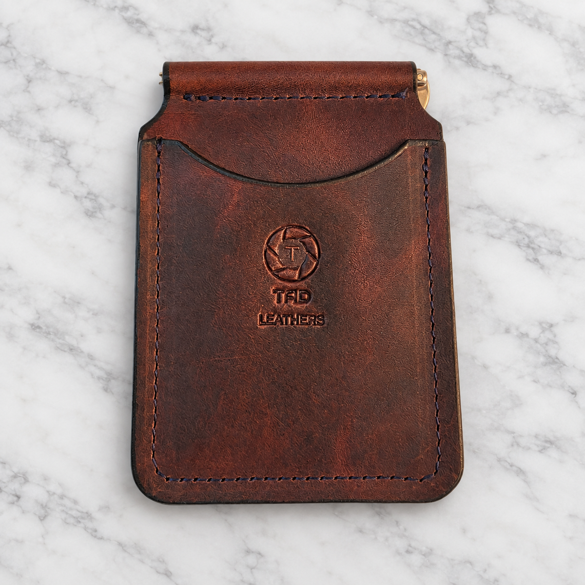 Chocolate Brown Leather Money Clip Wallet on light white and gray marble background