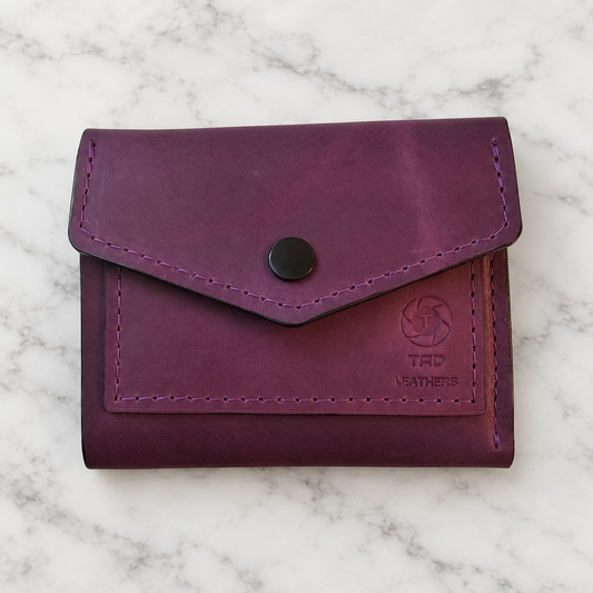 Imperial Purple Leather Snap Wallet on light marble background