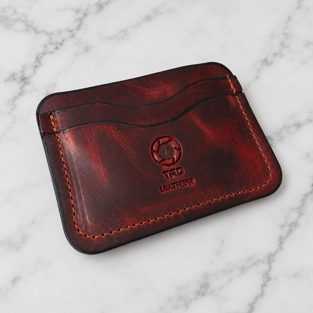 Full-Grain Leather Card Holder- Volcano Red on light marble background