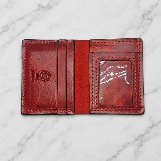 Crimson Full-Grain Leather ID Wallet on light marble background