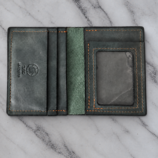 Green charcoal leather ID wallet on natural marble background