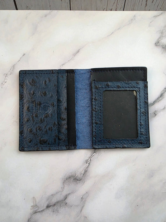 Midnight blue textured leather ID wallet — interior view on marble