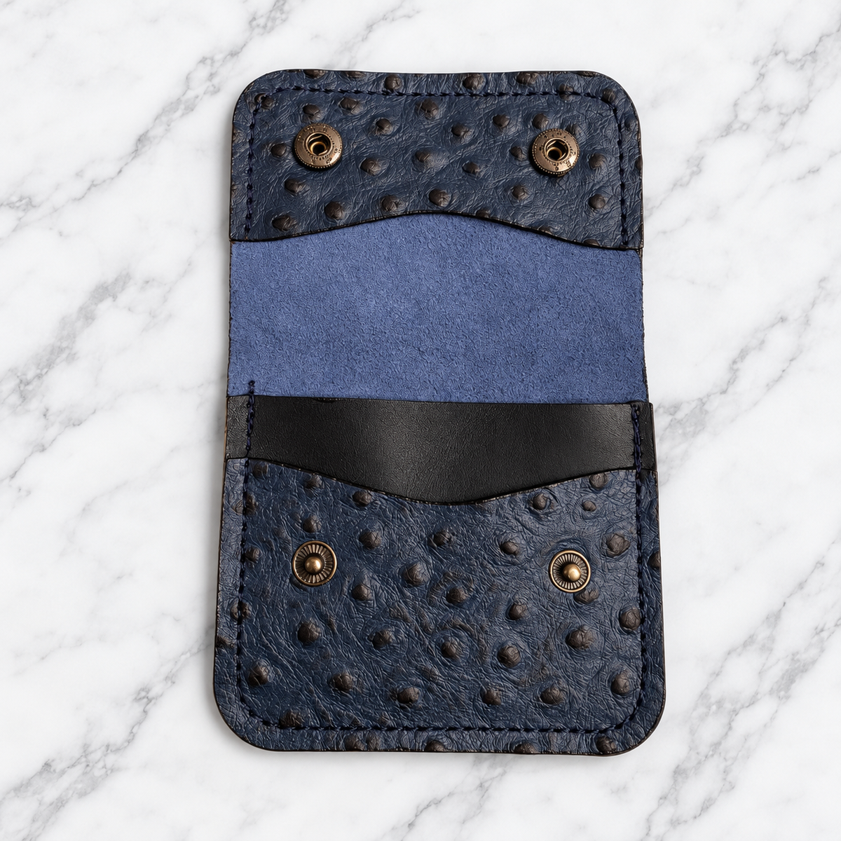 Open midnight blue snap wallet showing interior pockets