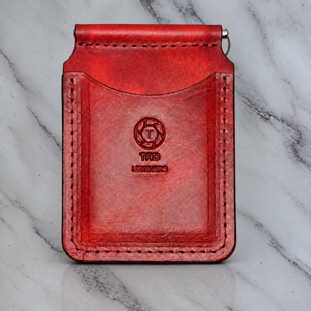 Red leather money clip wallet on natural marble background