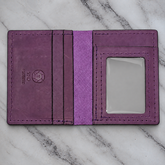 Royal plum leather ID wallet on natural marble background