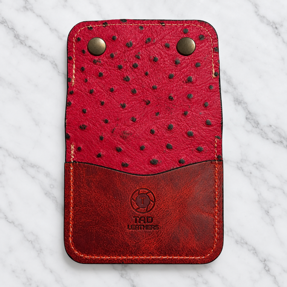 Ruby red snap wallet back with upright Tad Leathers logo