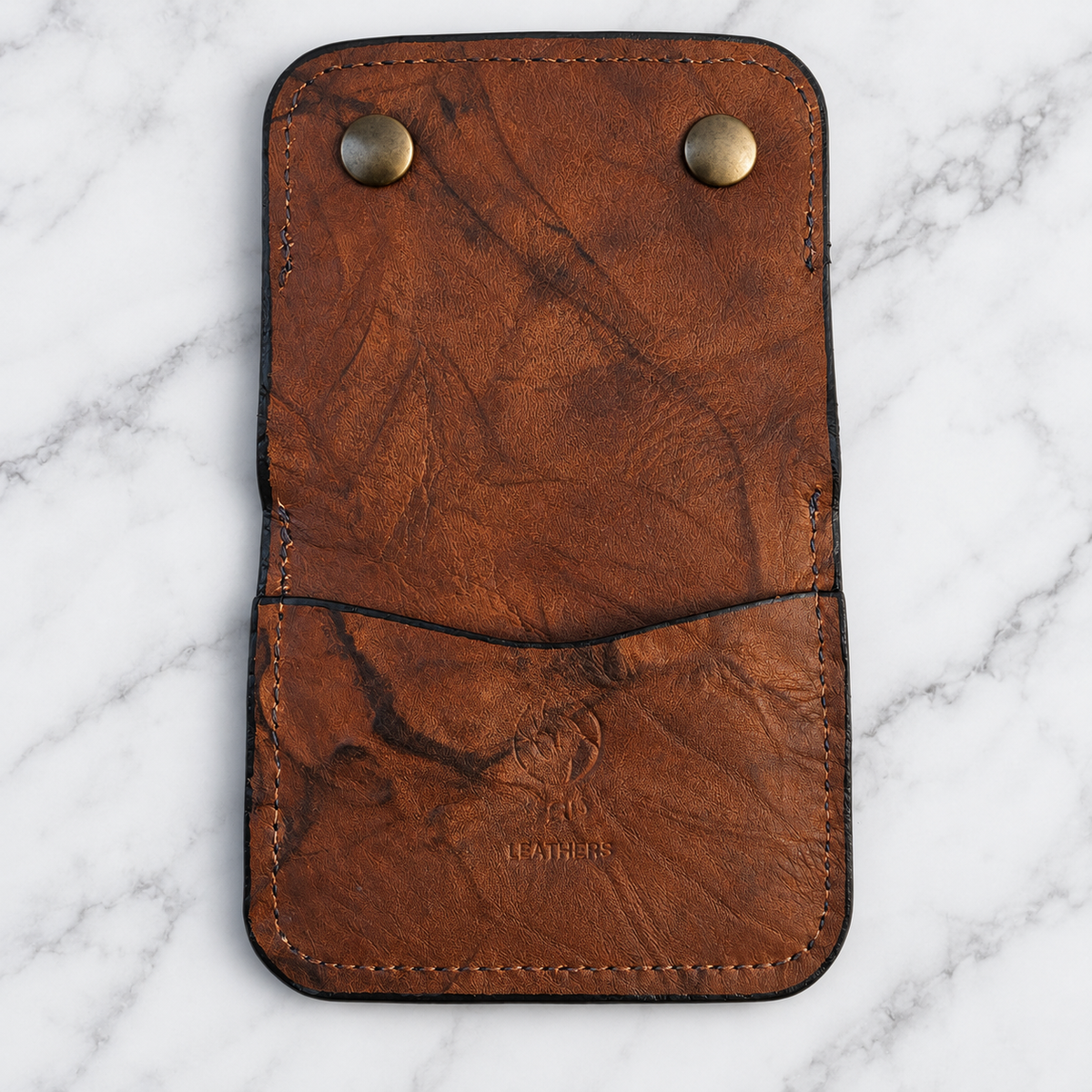 Open exterior showing rear pocket and Tad Leathers stamp
