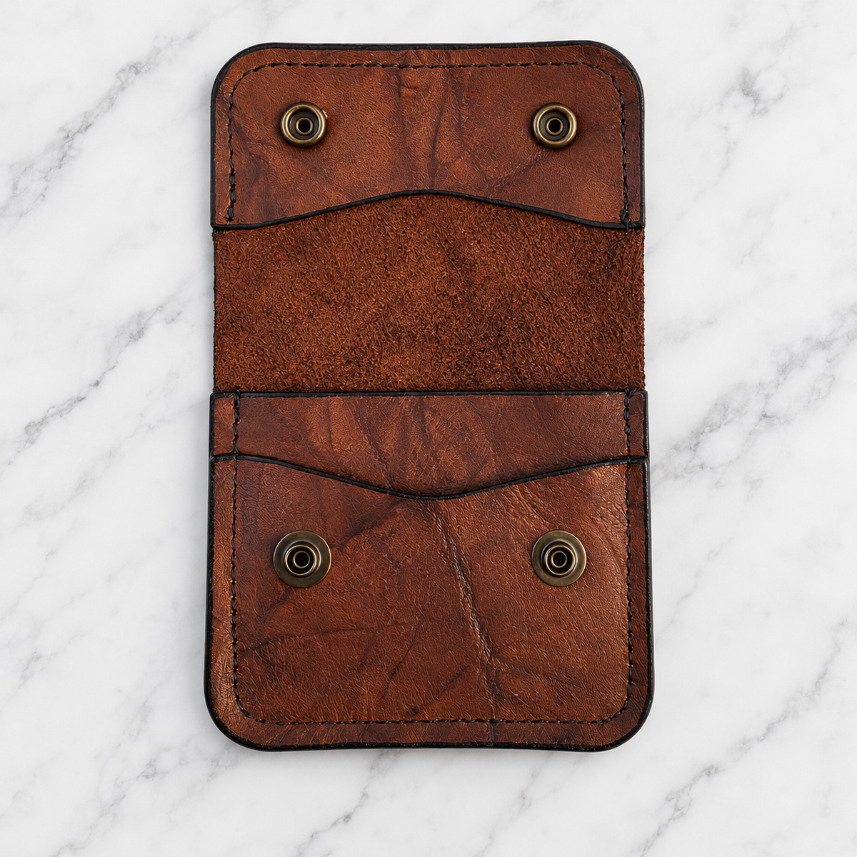 Open rustic brown snap wallet showing interior pockets