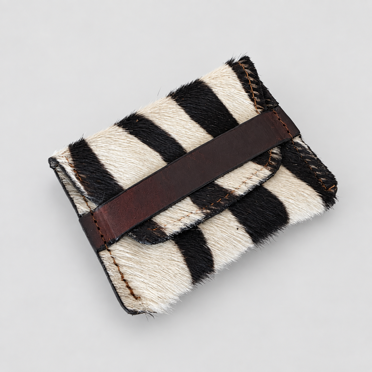 Handcrafted black and cream zebra-pattern leather pouch, alternate angled view