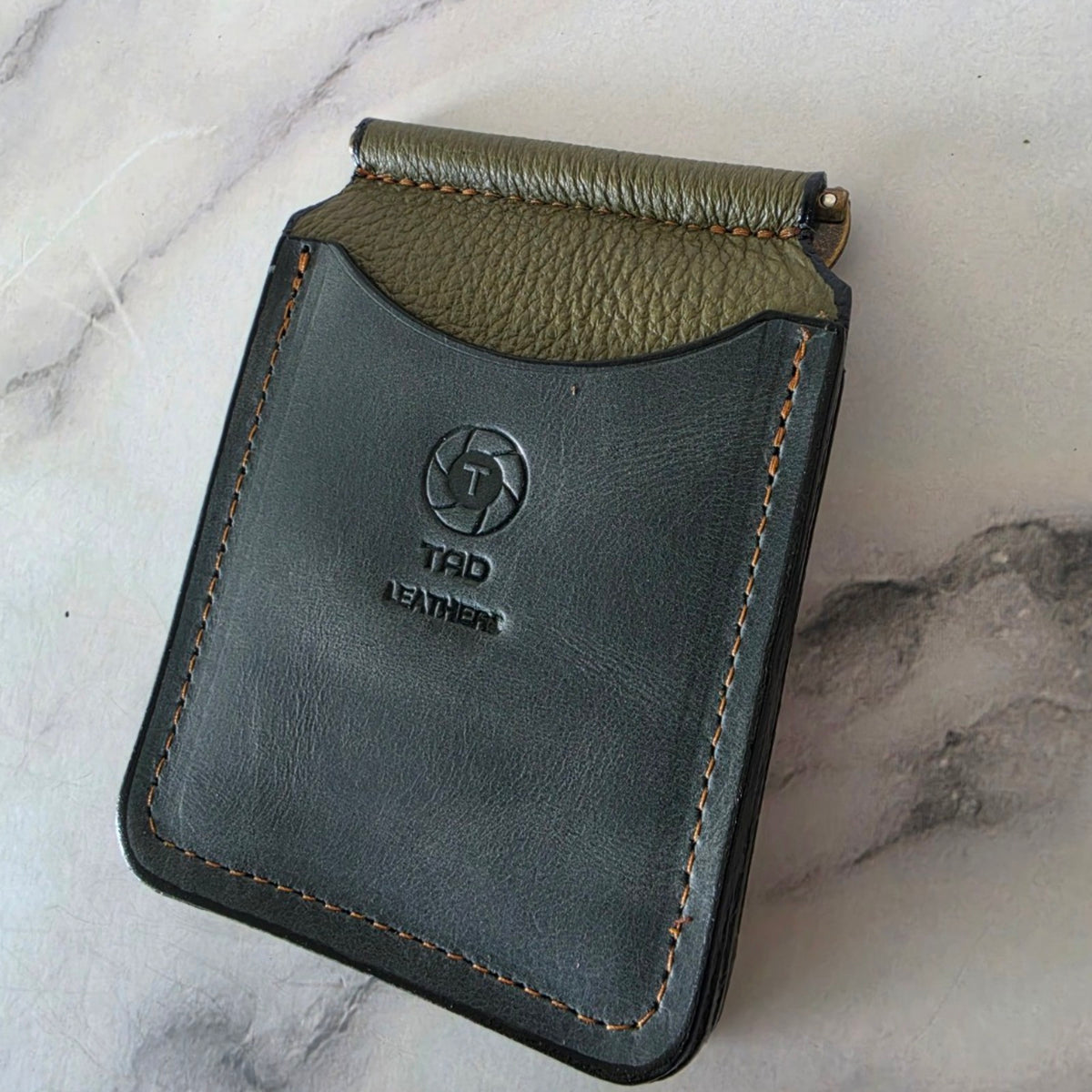 Handmade charcoal and olive leather money clip wallet shown at an angle