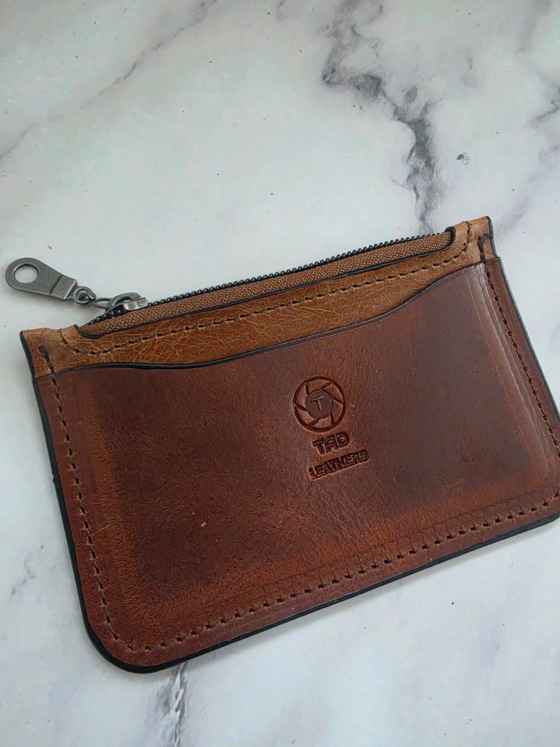 Cognac Brown leather zipper pouch angled view